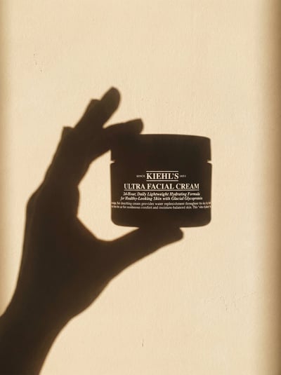Minimal Sunlit Wall Shadow of Hand Holding Uploaded Product with Projected Label Typography thumbnail